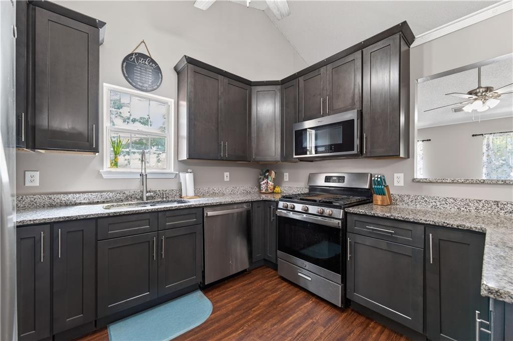 3904 Keystone Ridge Acworth, GA 30101 - Photo 31 of 45 a kitchen with stainless steel appliances granite countertop a stove a sink and a microwave