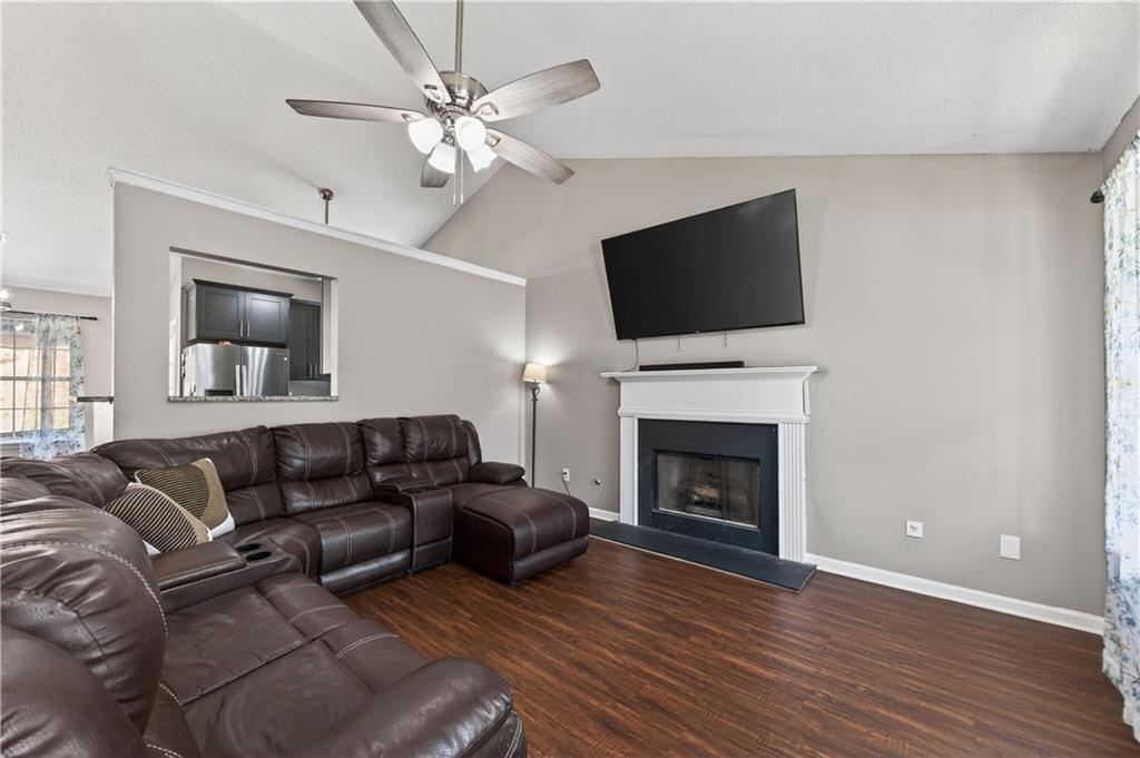 3904 Keystone Ridge Acworth, GA 30101 - Photo 38 of 45 a living room with furniture a fireplace and a flat screen tv