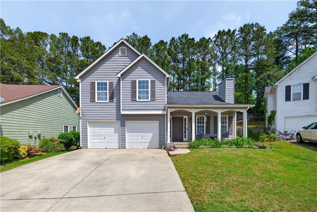 3904 Keystone Ridge Acworth, GA 30101 - Photo 8 of 45 a front view of a house with a yard and garage