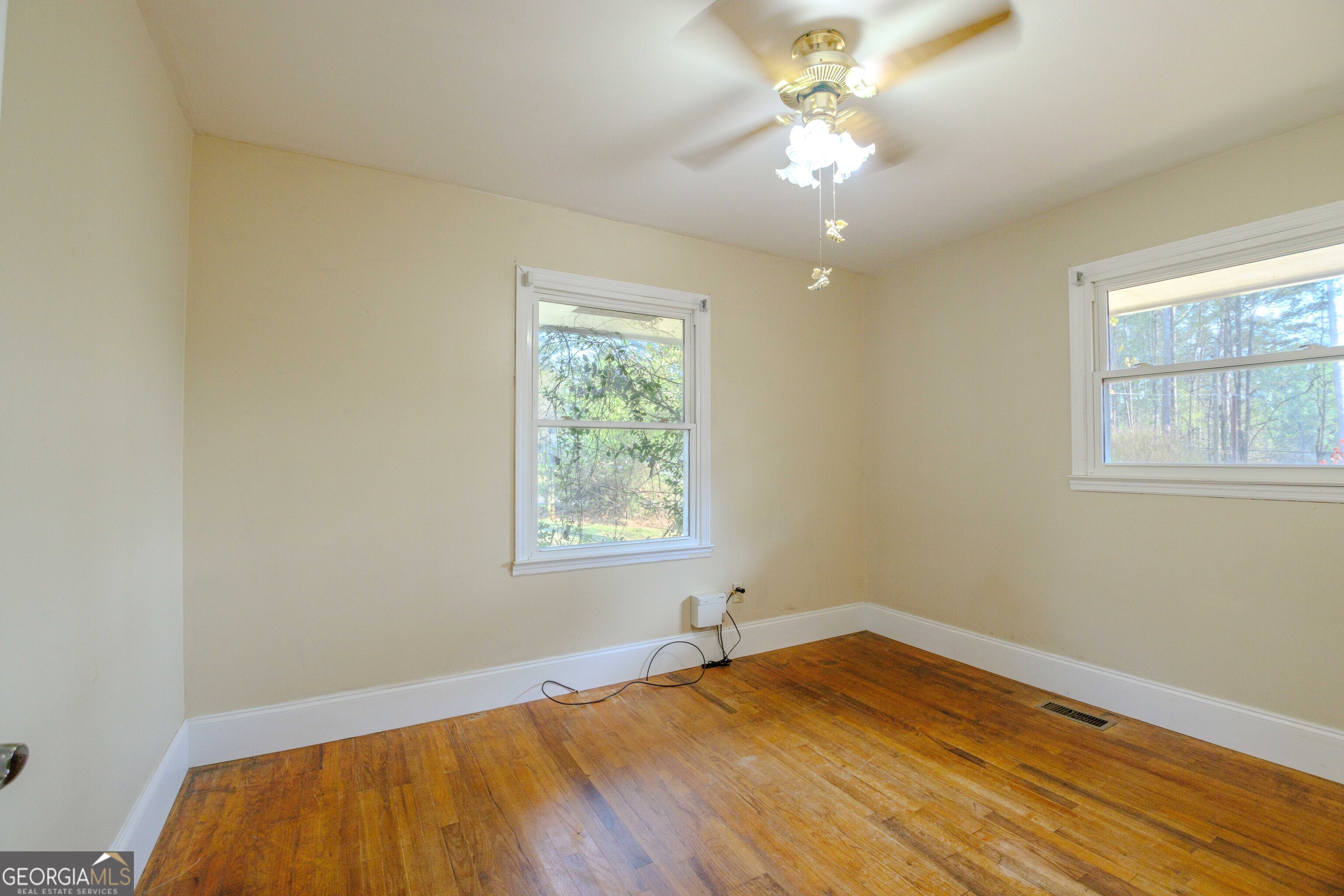 239 Hendry Lane Washington, GA 30673 - Photo 13 of 31 a view of an empty room with window and wooden floor