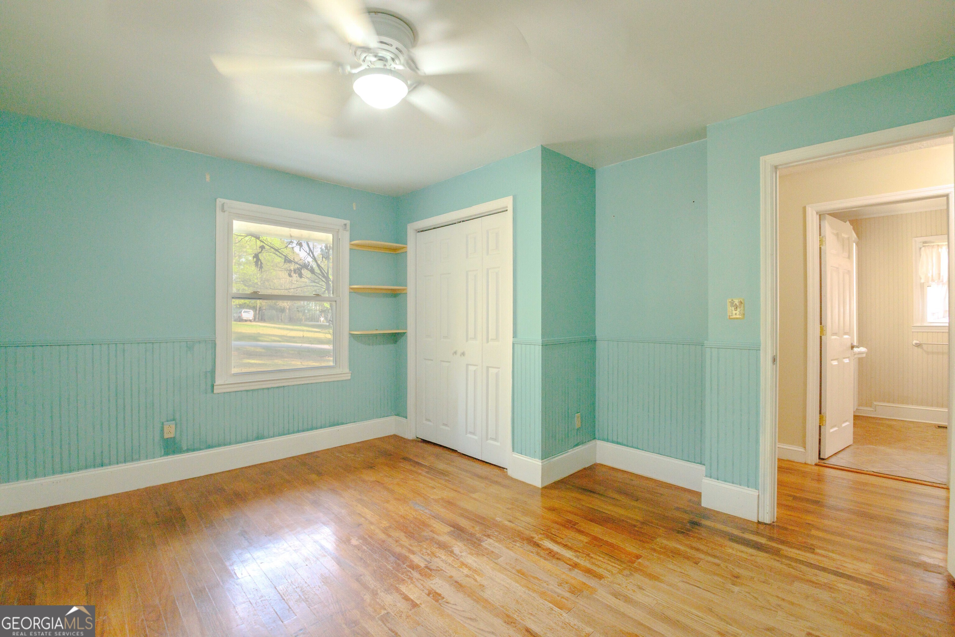 239 Hendry Lane Washington, GA 30673 - Photo 15 of 31 a view of empty room with wooden floor and fan