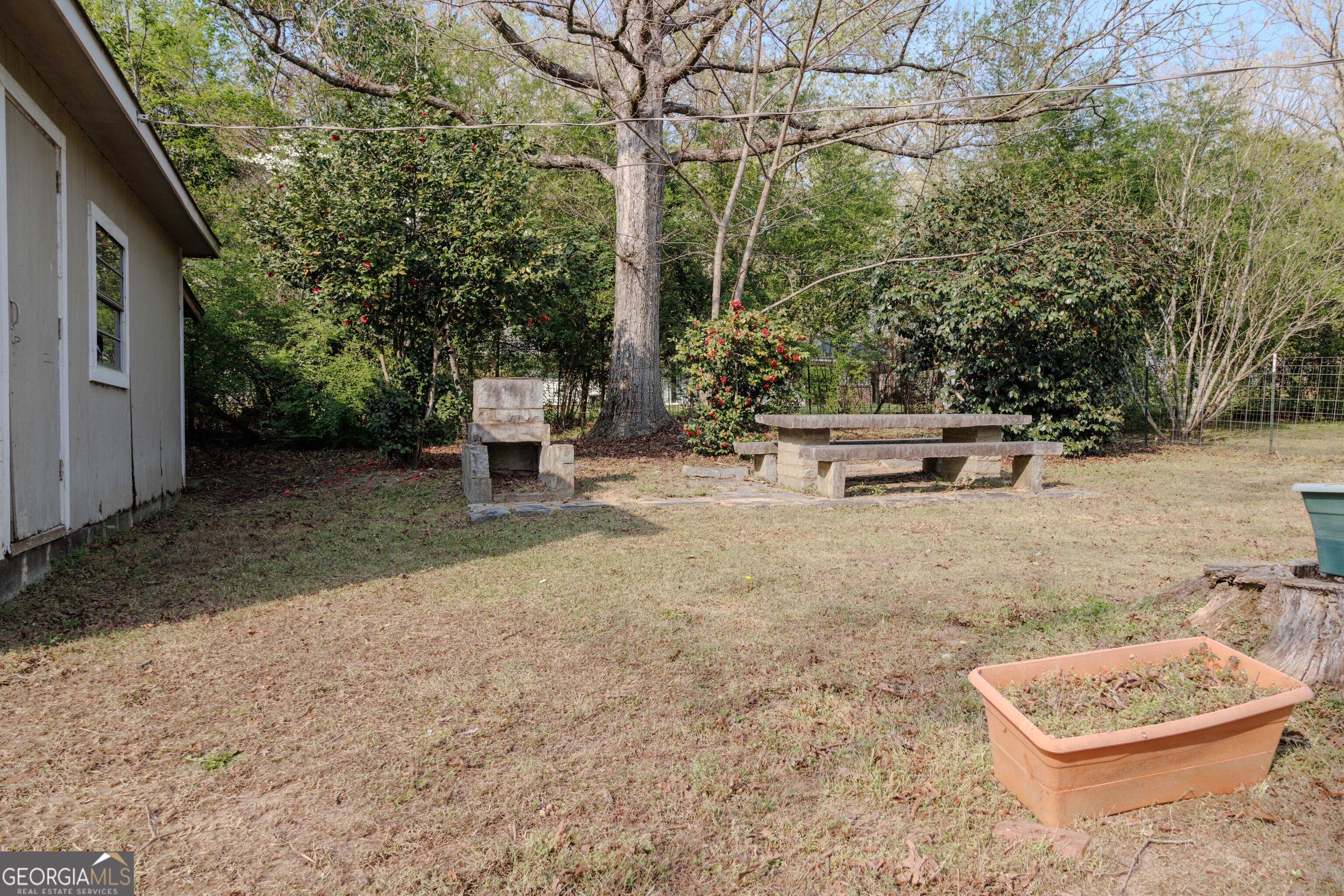 239 Hendry Lane Washington, GA 30673 - Photo 28 of 31 a backyard of a house with barbeque oven fire pit table and chairs