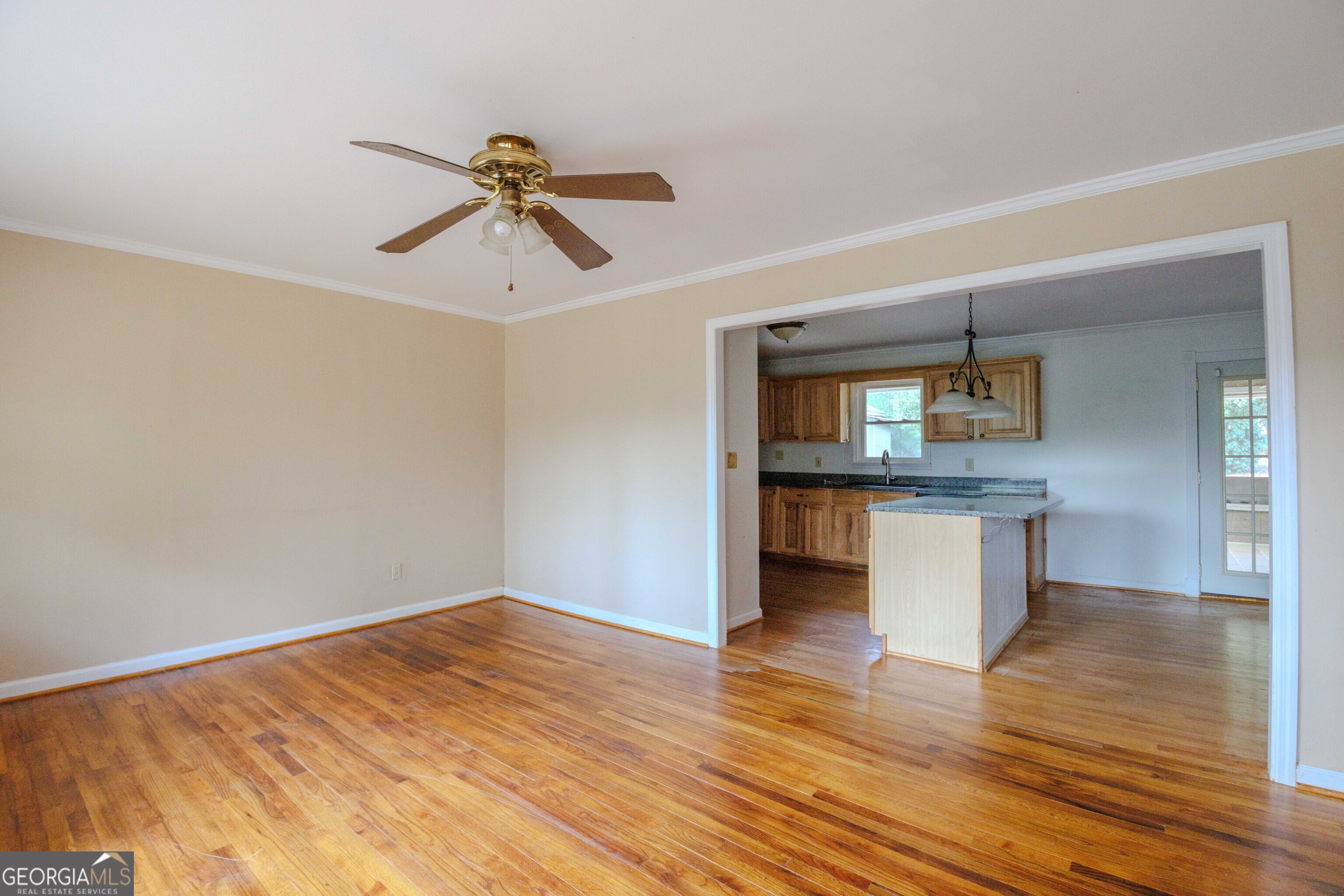 239 Hendry Lane Washington, GA 30673 - Photo 3 of 31 a view of empty room with wooden floor and window