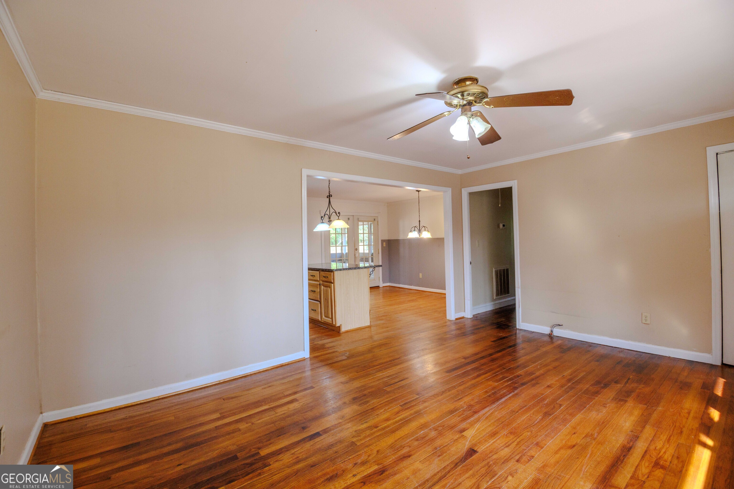 239 Hendry Lane Washington, GA 30673 - Photo 4 of 31 a view of an empty room with window and wooden floor