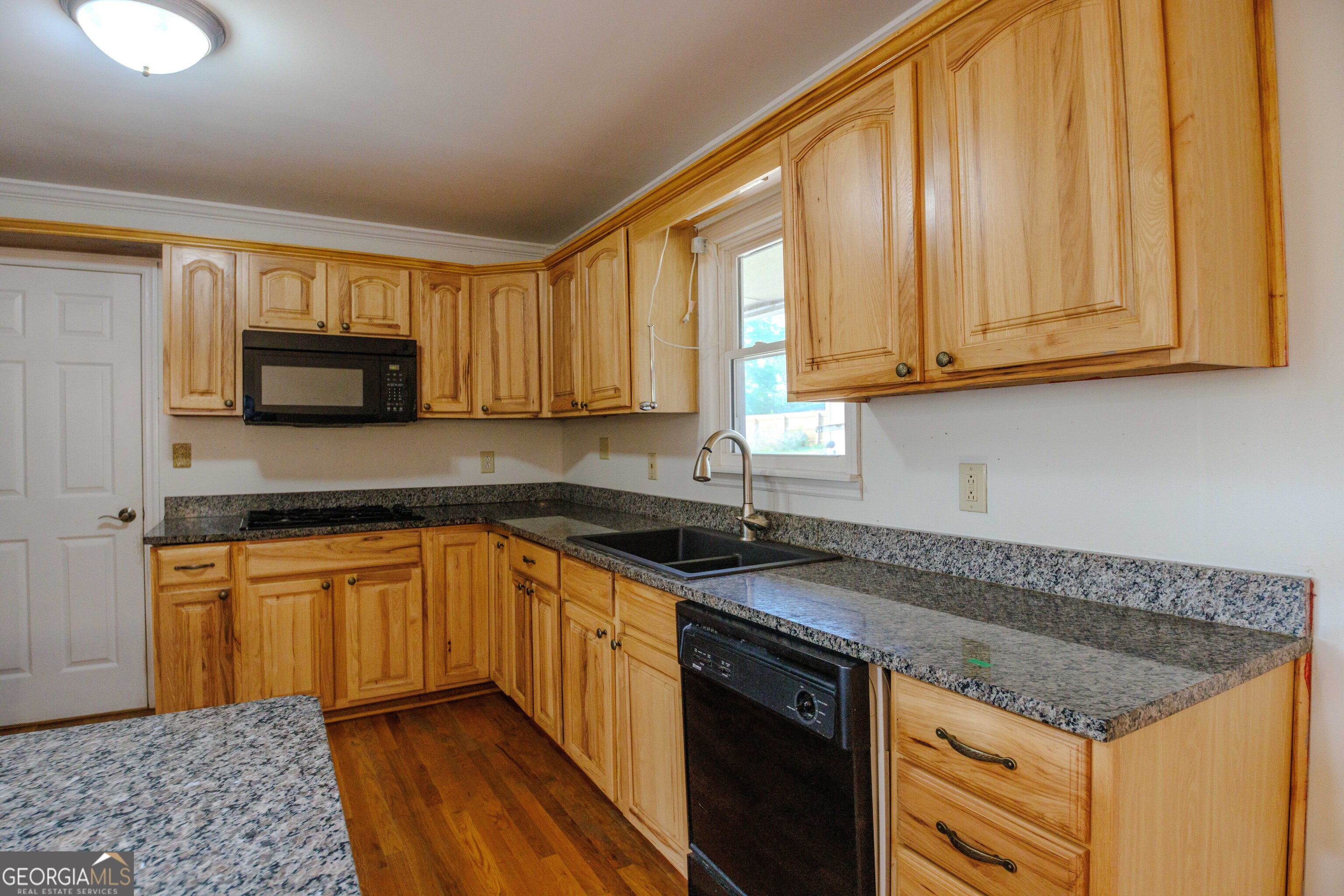 239 Hendry Lane Washington, GA 30673 - Photo 6 of 31 a kitchen with granite countertop a sink and a stove top oven