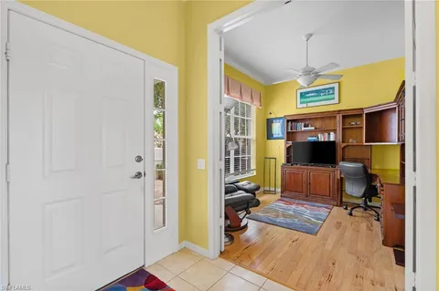 a view of a livingroom with workspace and a window
