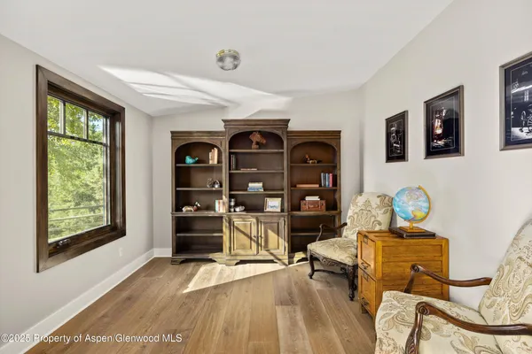 a living room with furniture a couch and large window