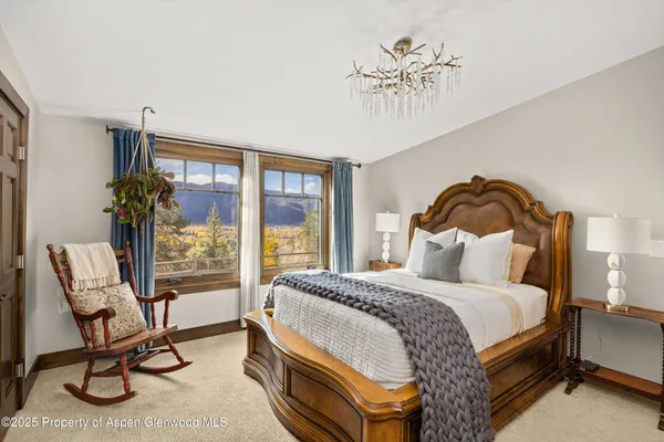 a bedroom with a bed chair and a window