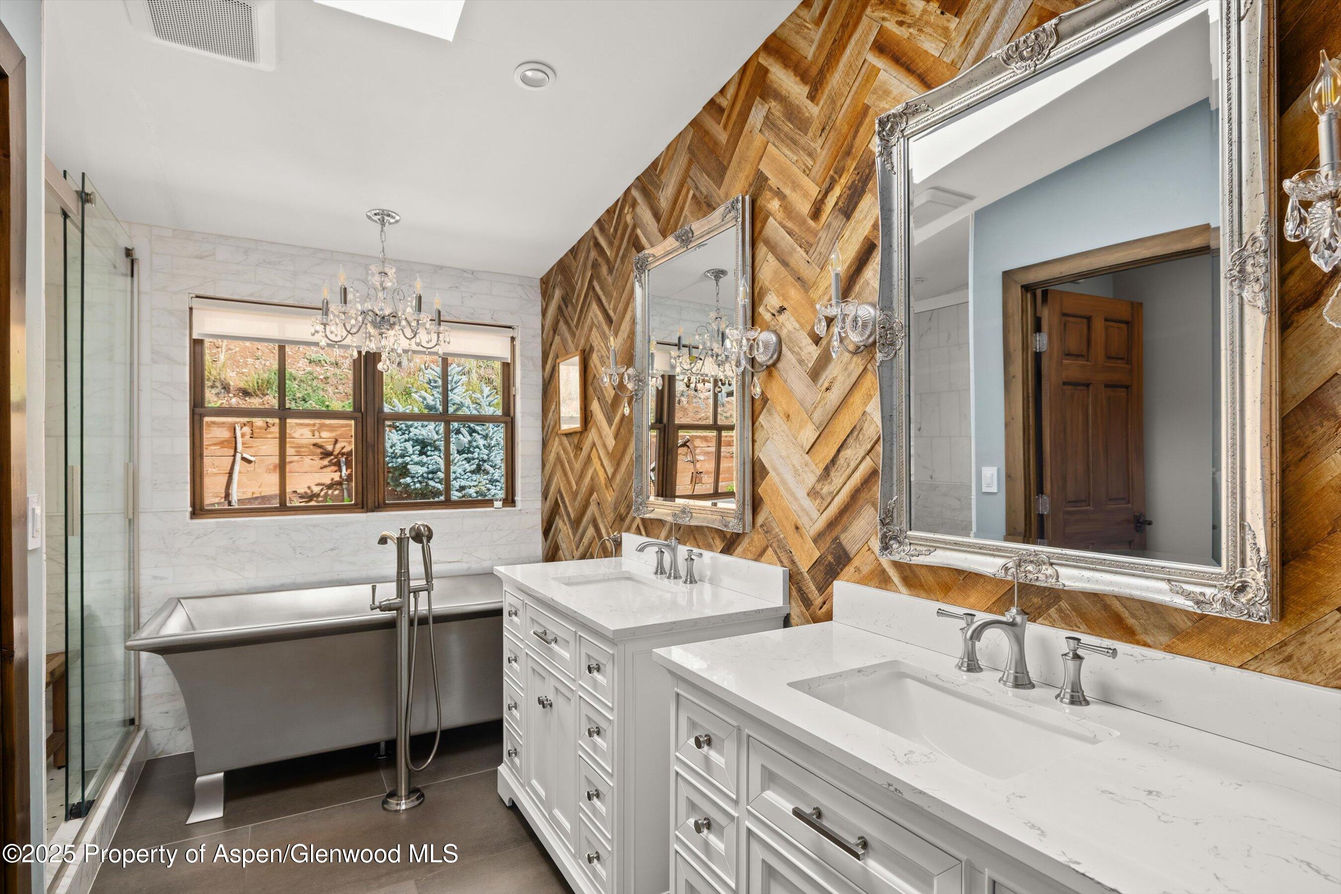 641 Pinon Drive Basalt, CO 81621 - Photo 7 of 17 a bathroom with a double vanity sink mirror and a bathtub