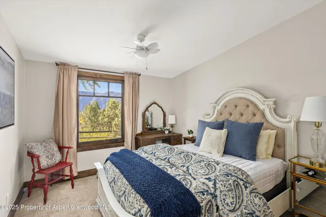 a living room with furniture a couch and large window