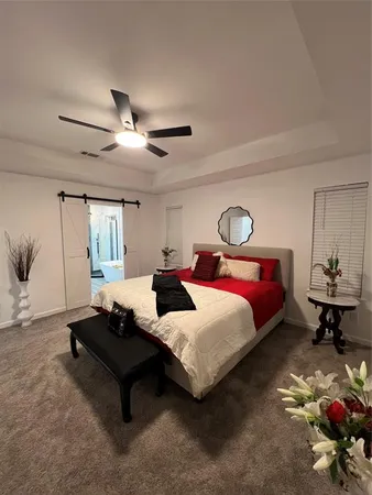 a spacious bedroom with a bed and window