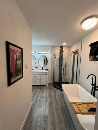 a spacious bathroom with a toilet a sink and mirror