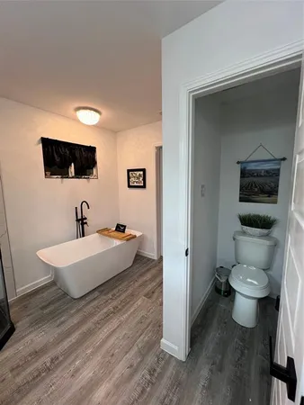 a bedroom with a bed and a view of bathroom