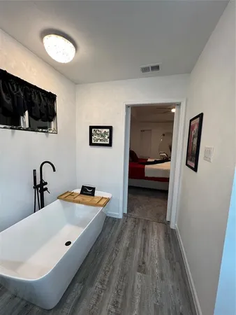 a bedroom with a bed and a mirror