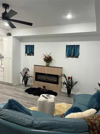 a living room with furniture a table and wooden floor
