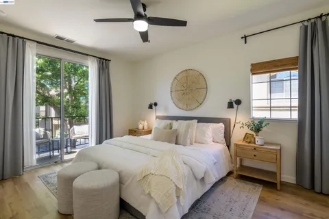 a bed room with a bed mirror and a window