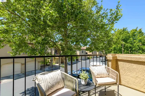 a view of a balcony with chairs
