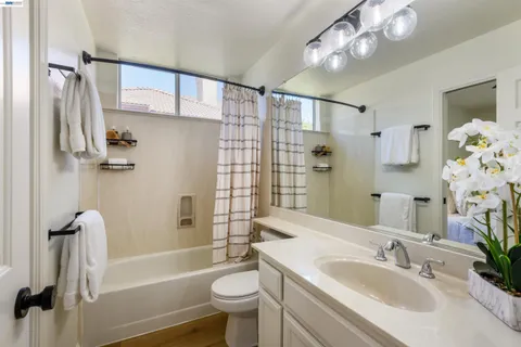 a bathroom with a sink toilet tub and shower
