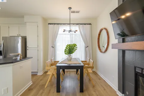 a living room with furniture a flat screen tv and a wall clock