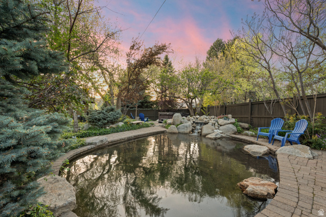 10280 Dimple Dell Road Sandy, UT 84092 - Photo 24 of 58 View of garden pond, a fenced backyard, and patio surround