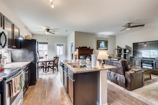 a living room with furniture and a wooden floor