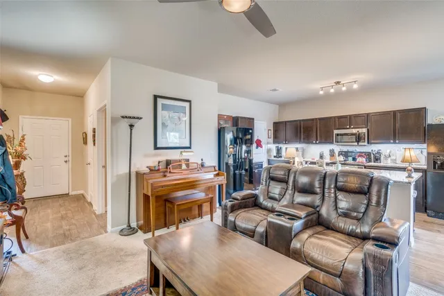 a living room with furniture and a kitchen view