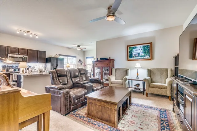 a living room with furniture kitchen view and a table