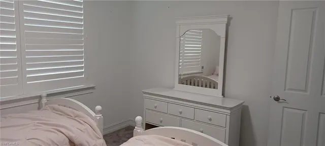 a bathroom with a toilet a sink a vanity and mirror