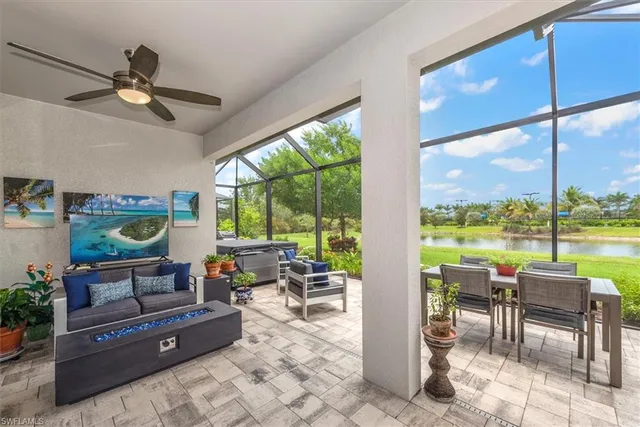 a living room with furniture and a floor to ceiling window