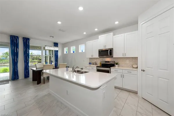 a kitchen with a sink stove and cabinets