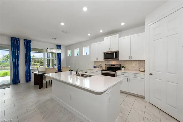 a kitchen with a sink stove and cabinets