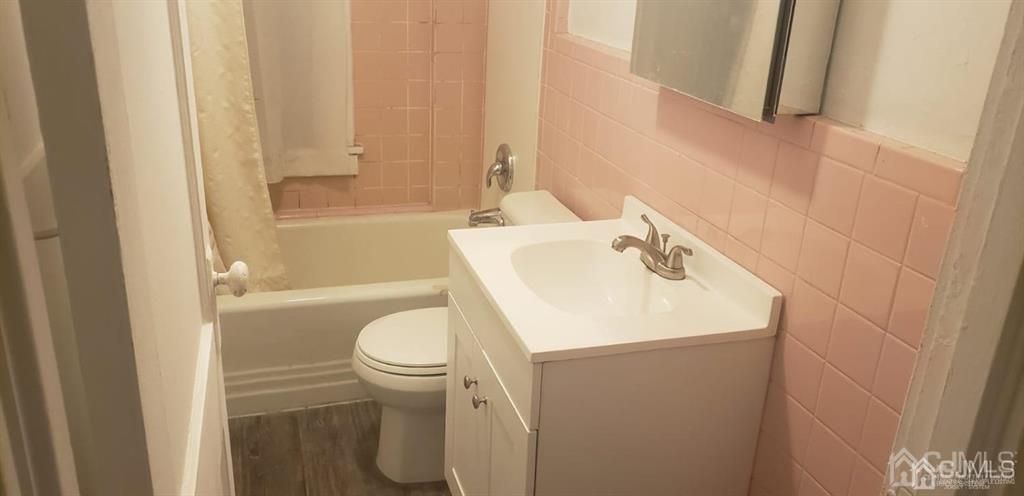 417 Chestnut Street, Unit B Middlesex, NJ 08846 - Photo 11 of 12 a bathroom with a sink a toilet and shower
