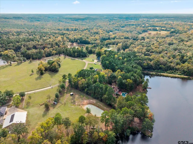 an aerial view of ocean residential house with outdoor space and trees around