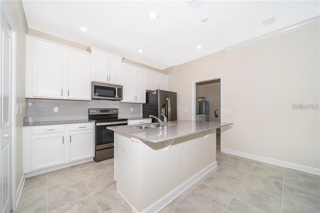 17053 Volume Alley Winter Garden, FL 34787 - Photo 15 of 15 a kitchen with a sink stove and microwave