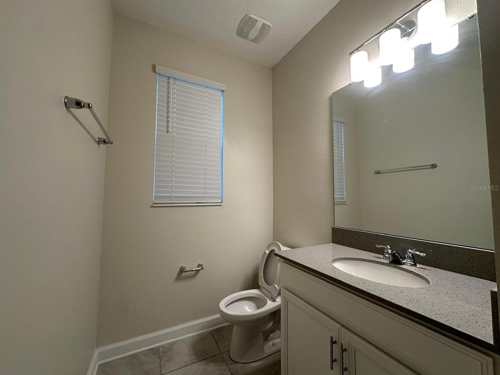 17053 Volume Alley Winter Garden, FL 34787 - Photo 4 of 15 a bathroom with a granite countertop toilet sink and mirror