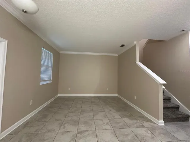 a view of an empty room with white walls