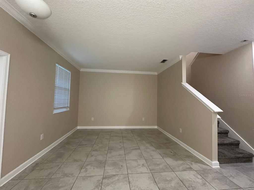 17053 Volume Alley Winter Garden, FL 34787 - Photo 8 of 15 a view of an empty room with white walls