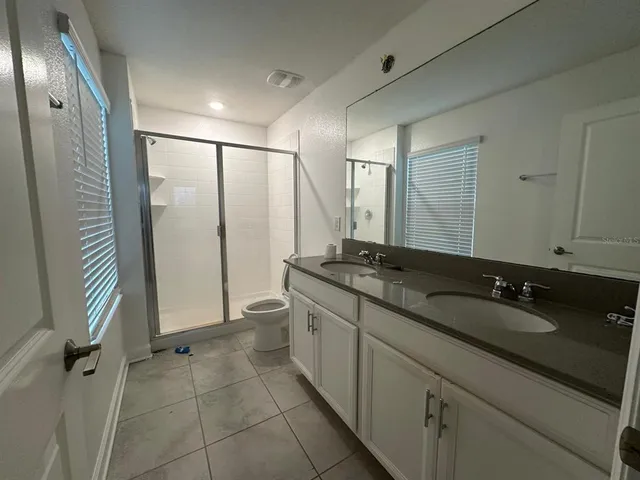 a bathroom with a double vanity sink and mirror