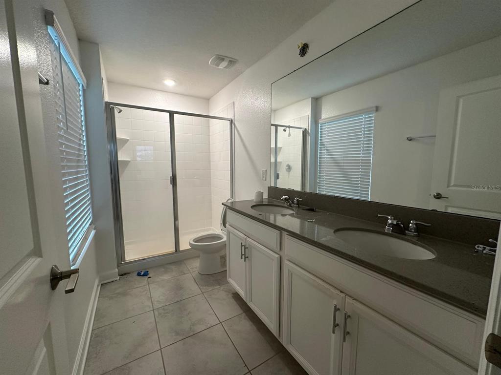 17053 Volume Alley Winter Garden, FL 34787 - Photo 10 of 15 a bathroom with a double vanity sink and mirror