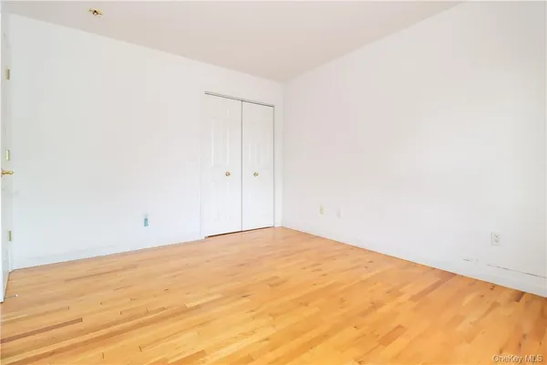 a bedroom with furniture and a wooden floor
