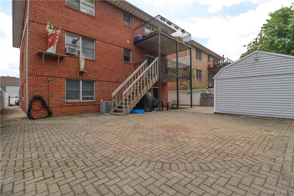 a view of a white house with a yard and large tree