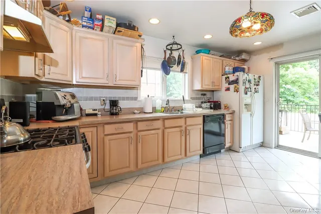 a kitchen with a white cabinets and window