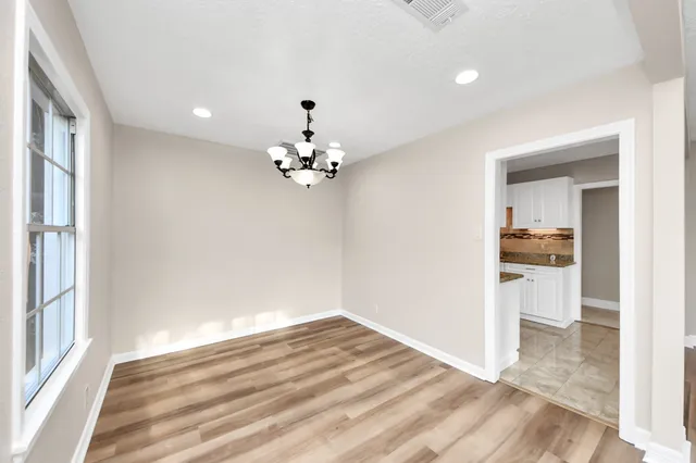 a view of a kitchen with a dishwasher cabinets and a wooden floor