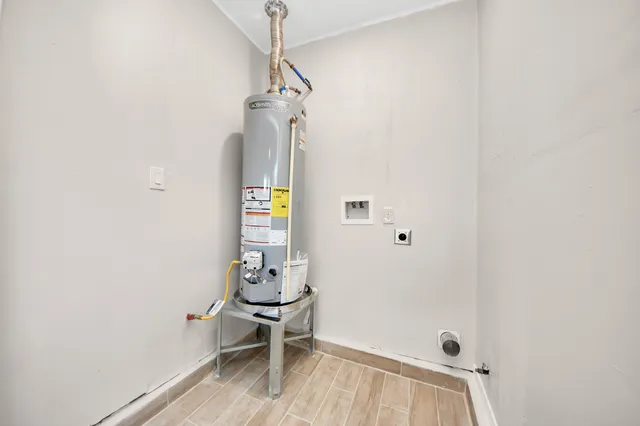 a view of a hallway with wooden floor and a table