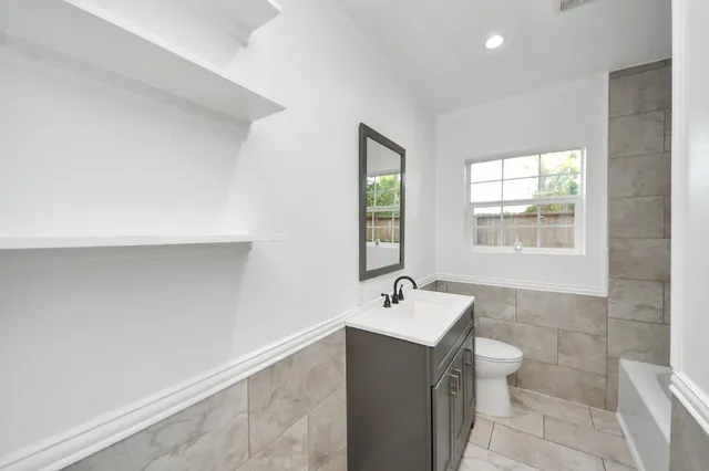 a bathroom with a bathtub and a sink
