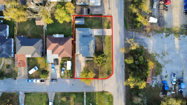 an aerial view of multiple houses with a yard