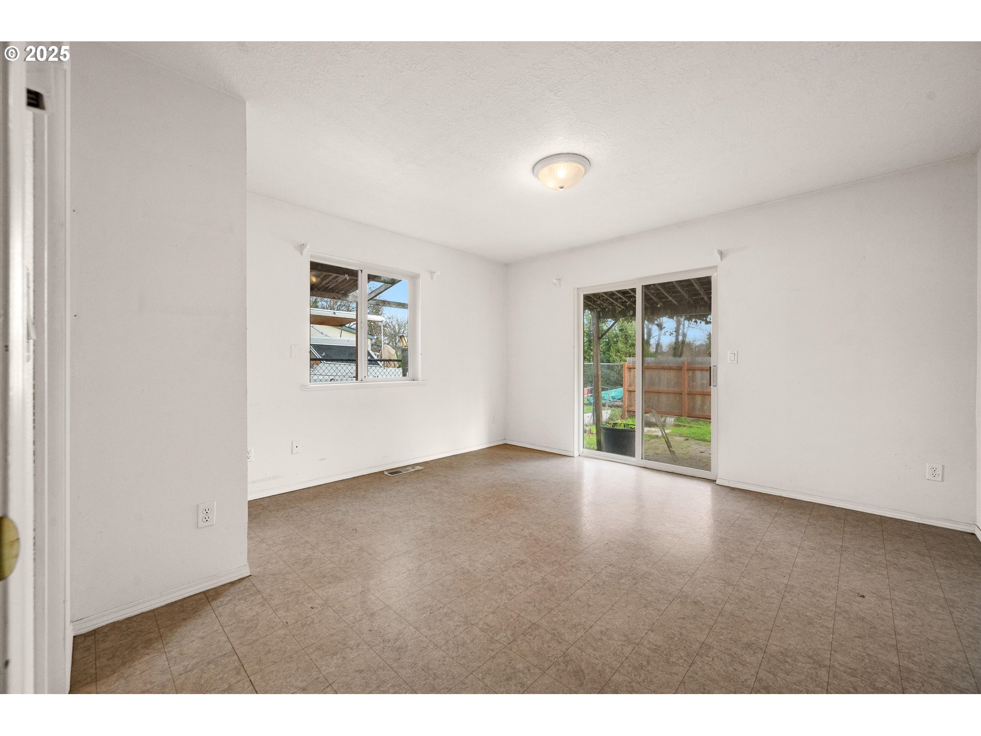 9620 Wells Landing Road Independence, OR 97351 - Photo 11 of 22 a view of a big room with wooden floor and windows