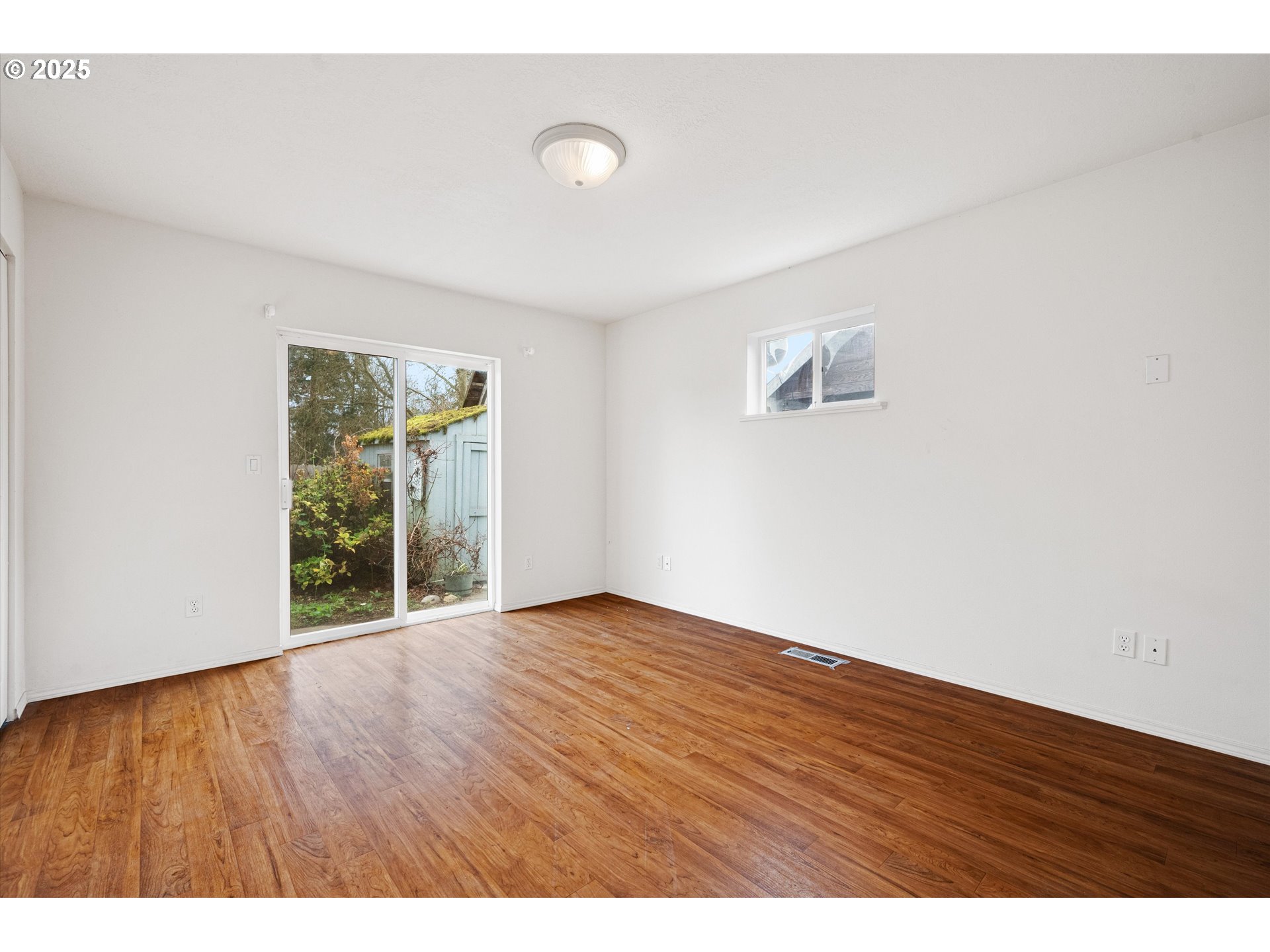 9620 Wells Landing Road Independence, OR 97351 - Photo 16 of 22 a view of an empty room with wooden floor