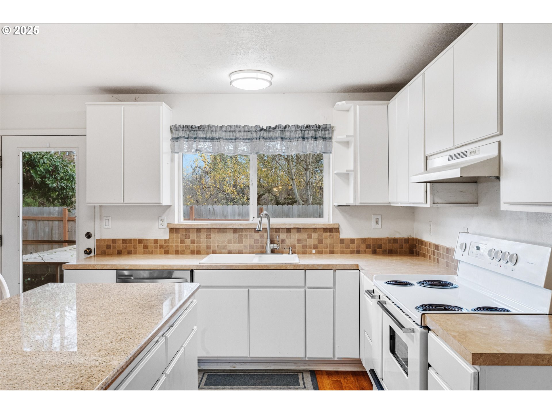 9620 Wells Landing Road Independence, OR 97351 - Photo 7 of 22 a kitchen with a sink stove and cabinets