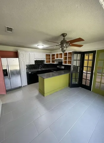 a kitchen with a sink and cabinets